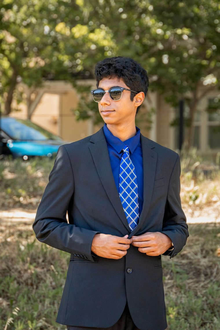Solo prom portrait in bright blue suit and sunglasses