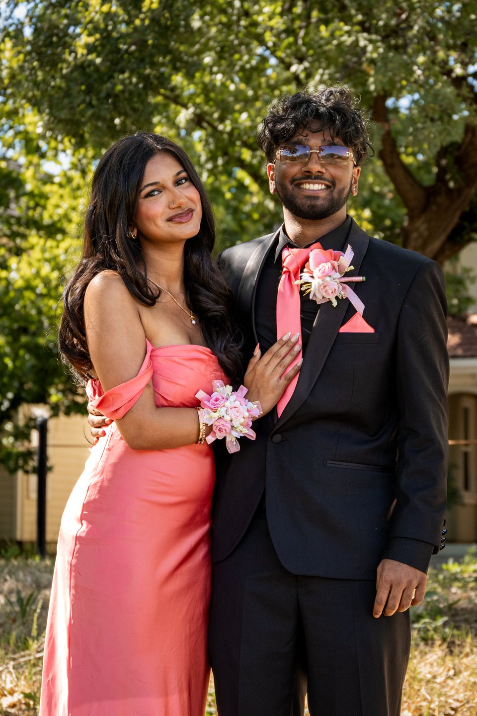 Pink-dress prom couple posed portrait