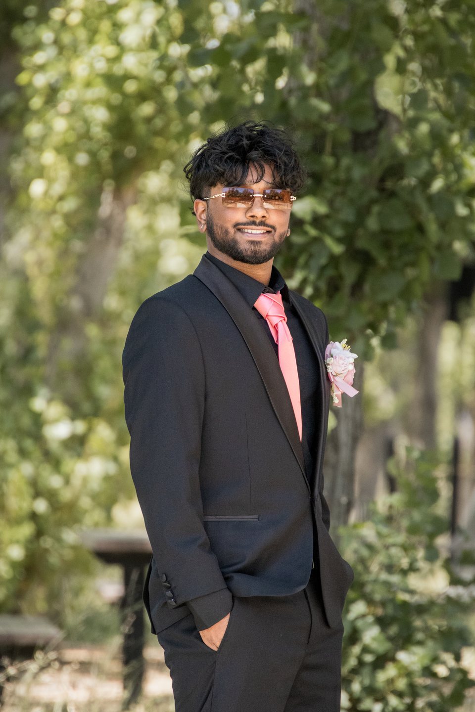 Solo prom portrait in black suit and pink tie