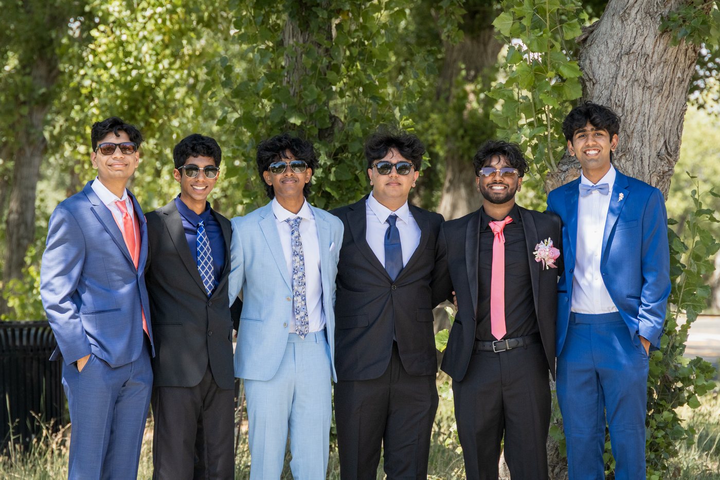 Formal group portrait of six students in suits